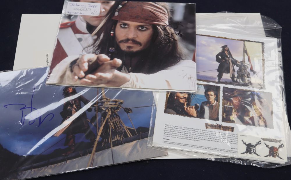 A Johnny Depp - Pirates of the Caribbean: The Curse of the Black Pearl Press Pack, containing two signed colour photographs